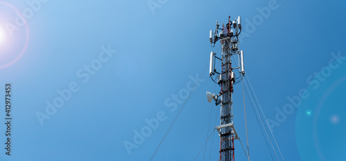 workers are working at 5g antenna tower for maintaining.serves cellular antenna, technician worker repair telecommunication tower on sunlight at background. 