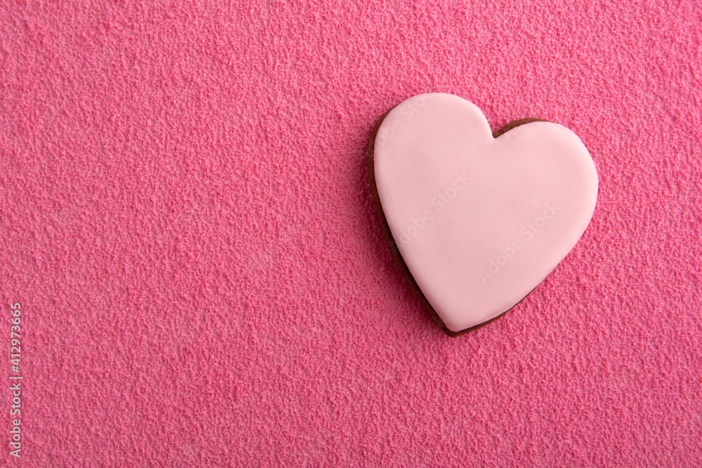 Fototapeta premium Cookies in shape of hearts with sugar icing on pink background. Space for text