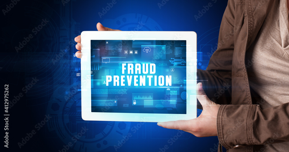 Young business person working on tablet and shows the digital sign: FRAUD PREVENTION Young business person working on tablet and shows the digital sign: FRAUD PREVENTION