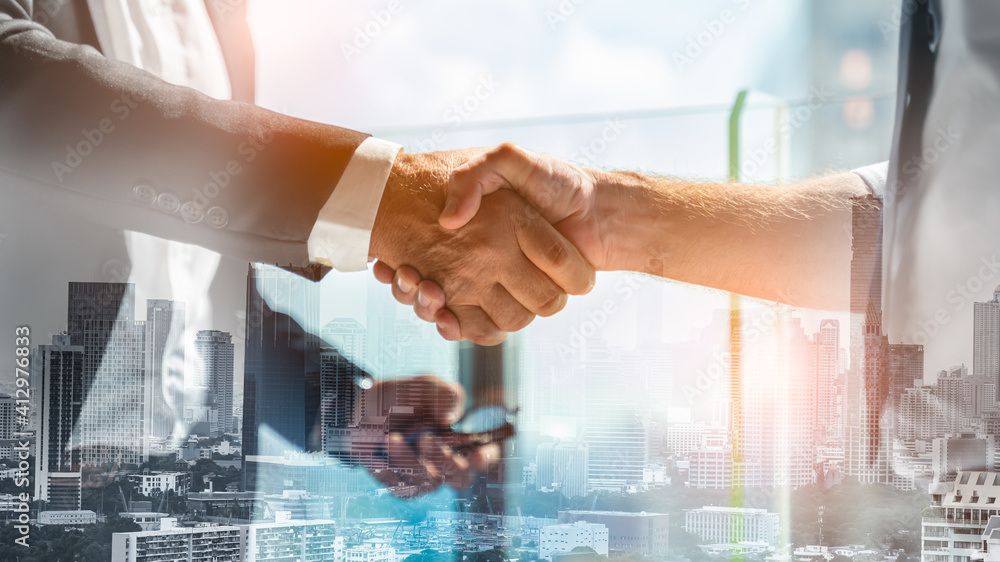 Businessman handshake for teamwork of business merger and acquisition,successful negotiate,hand shake,two businessman shake hand with partner to celebration partnership and business deal concept Businessman handshake for teamwork of business merger and acquisition,successful negotiate,hand shake,two businessman shake hand with partner to celebration partnership and business deal concept