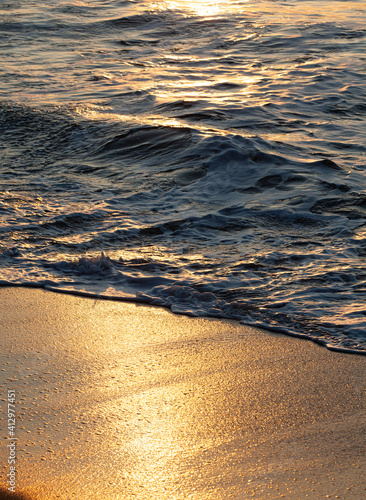 Sea waves water texture at sunrise