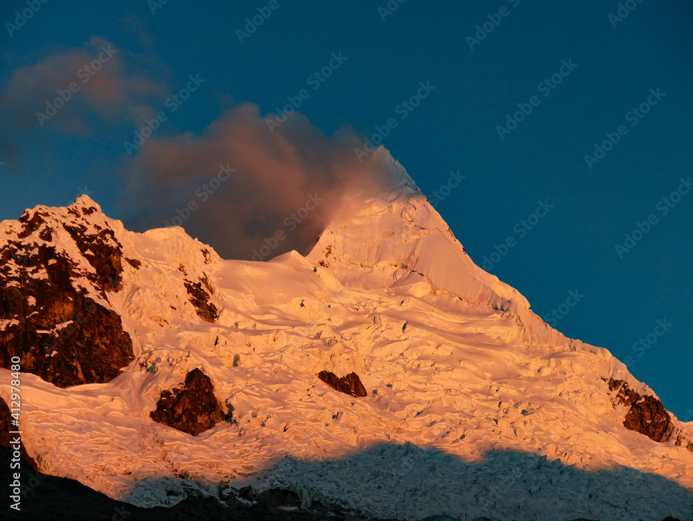 cordillera blanca trail huayhuash, mountain top by sunset getting red.
