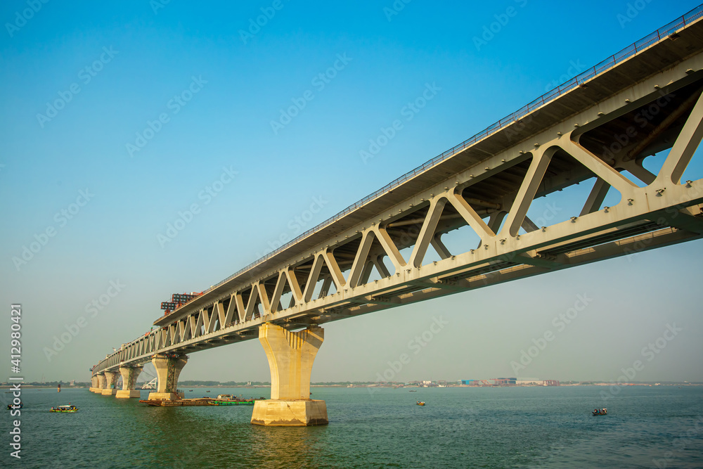 Bangladesh – February 06, 2021: A new PADMA Multipurpose Bridge is being constructed over the river Padma at Munshiganj, Dhaka, Bangladesh. Bangladesh – February 06, 2021: A new PADMA Multipurpose Bridge is being constructed over the river Padma at Munshiganj, Dhaka, Bangladesh.
