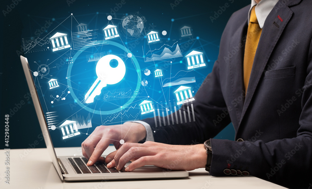 Business hand working on laptop with key icons coming out from the screen, successful business concept Business hand working on laptop with key icons coming out from the screen, successful business concept