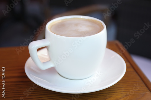 Aromatic coffee on wooden table outdoors, closeup