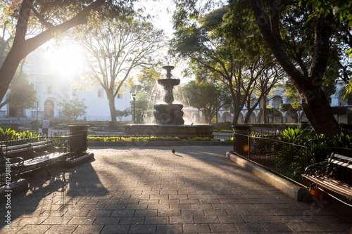 Central park of Antigua Guatemala at sunrise - Fountain of the Sirens in the middle of the park in colonial Guatemala City - Empty park early in the morning photo