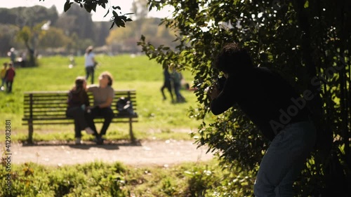 spy, tail - private detective secretly photographs a couple flirting in the park