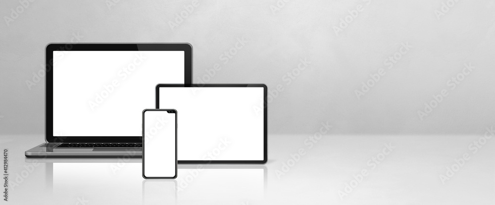 Laptop, mobile phone and digital tablet pc on white concrete office desk. Banner  background Stock Photo | Adobe Stock
