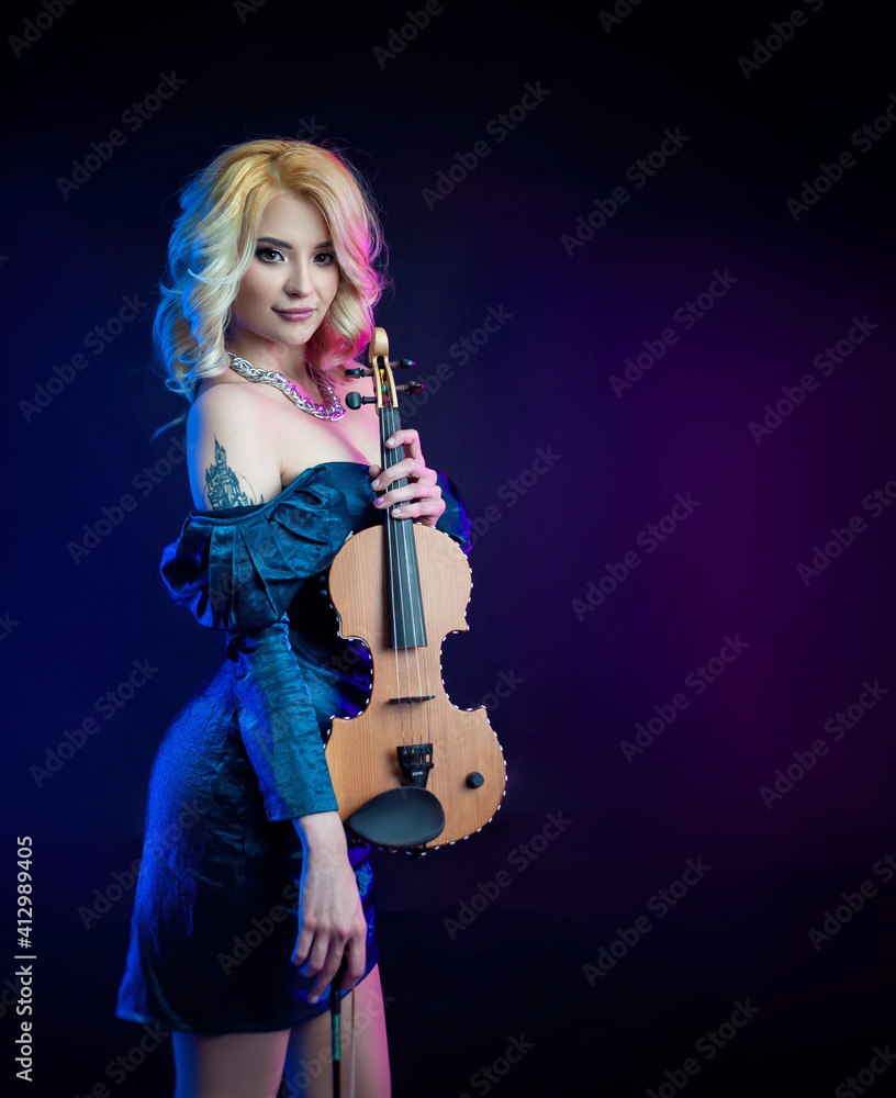 portrait of a blonde woman playing a violin in neon light