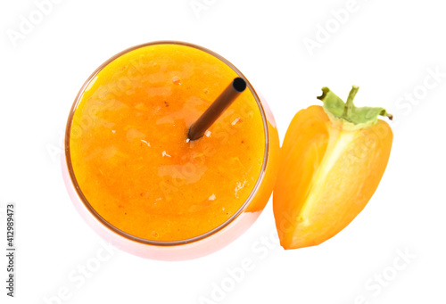 Tasty persimmon smoothie with straw and fruit isolated on white, top view