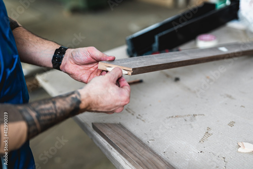 Focused professional carpenter working in his workshop, woodworking and craftsmanship concept. © hedgehog94