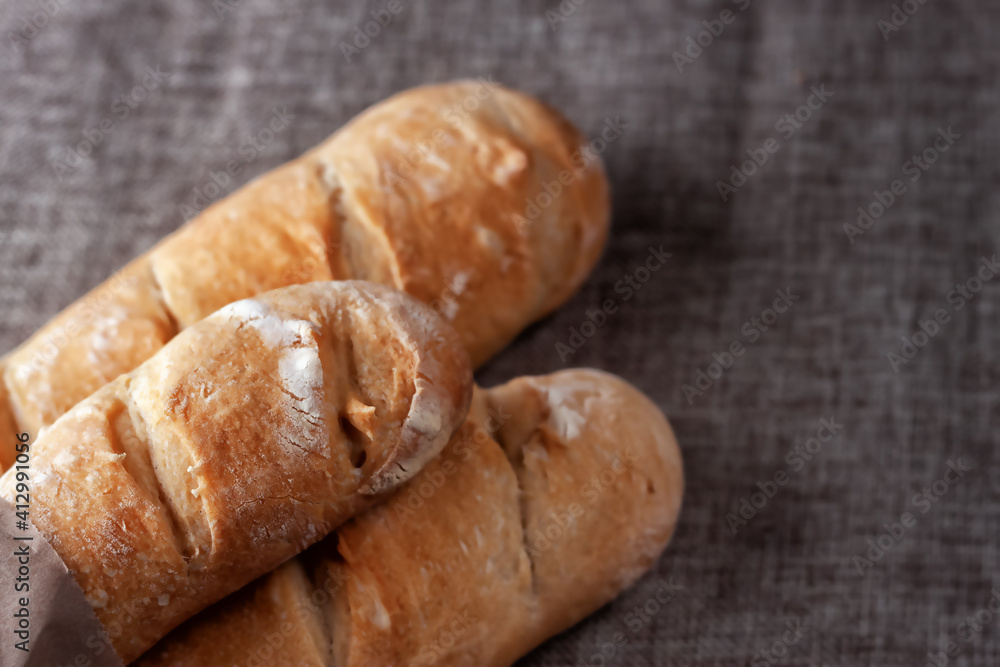 French baguettes on a table covered with cloth. Selective focus.