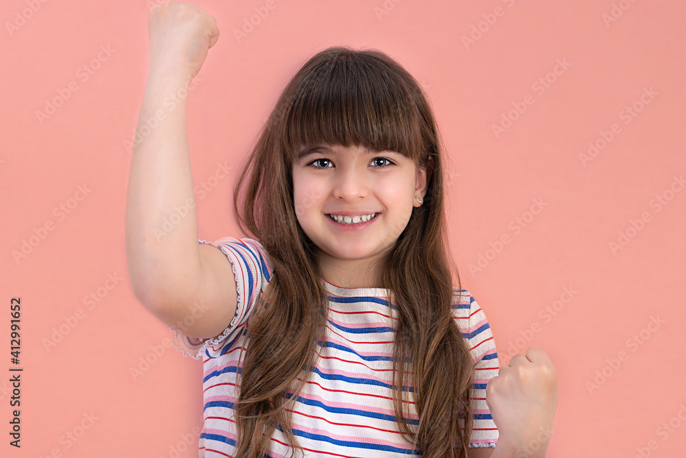 Fototapeta premium Portrait of a little happy girl showing a gesture of happiness