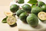 Fresh green feijoa fruits on light table, closeup