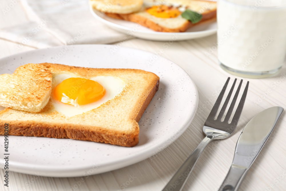 Tasty toast with fried egg served on white wooden table, closeup Tasty toast with fried egg served on white wooden table, closeup