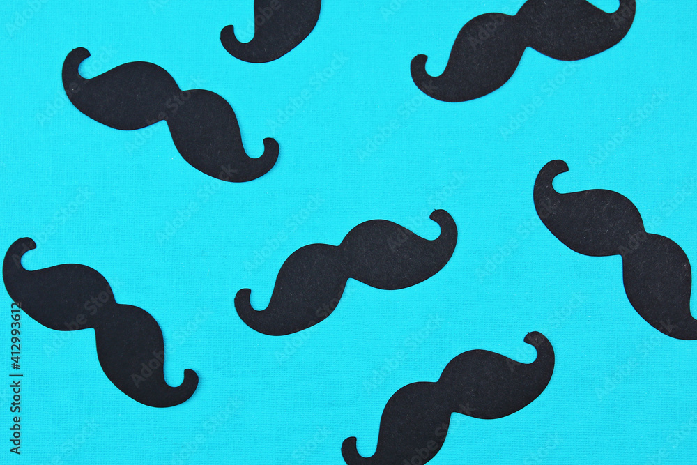 Father's day card background on blue background. Composition of mustache. Father's day holiday concept.