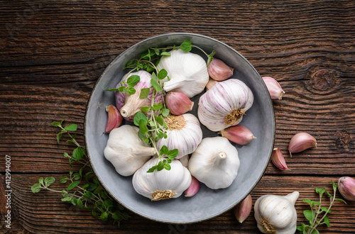 Natural antibiotic, fresh garlic bulbs with cloves on wooden background