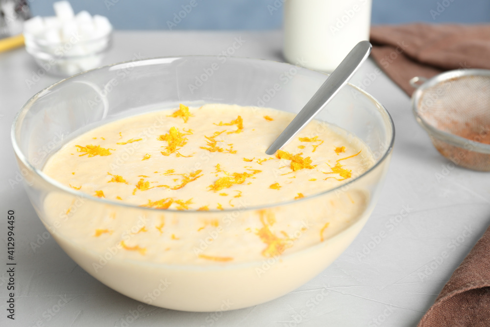Glass bowl with batter on light table in kitchen, closeup Glass bowl with batter on light table in kitchen, closeup