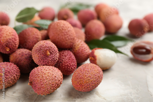 Fresh ripe lychee fruits on light grey table