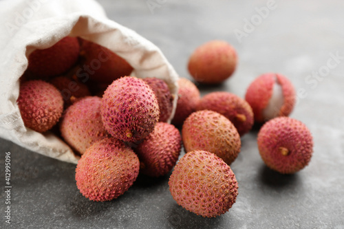 Fresh ripe lychee fruits on grey table