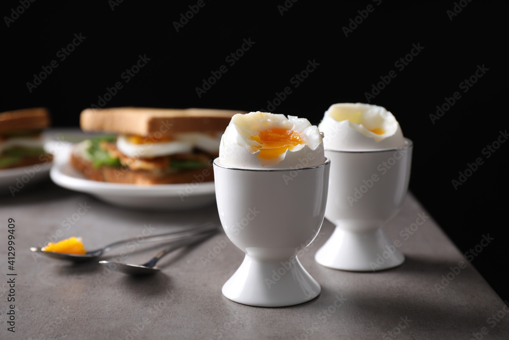 Soft boiled eggs served on grey table. Space for text Soft boiled eggs served on grey table. Space for text