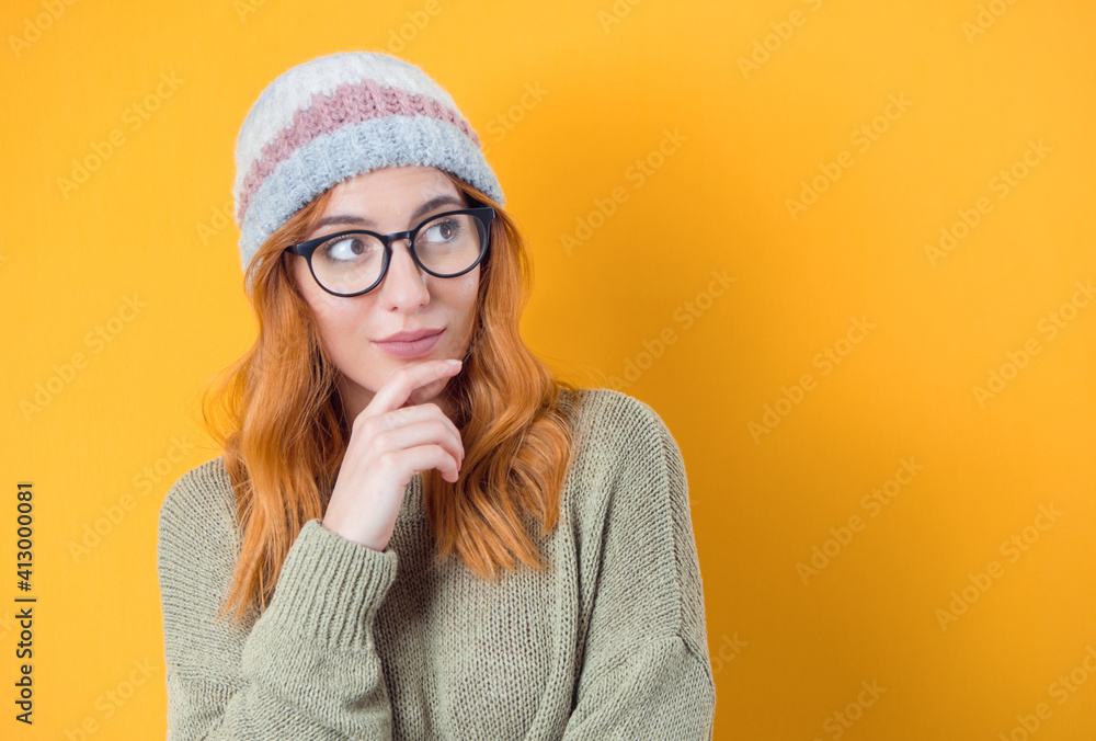 Young woman looking up with face expression imagination. Closeup portrait of decidedly inspired woman with smile face expression, isolated on yellow background. Female person with good idea Young woman looking up with face expression imagination. Closeup portrait of decidedly inspired woman with smile face expression, isolated on yellow background. Female person with good idea