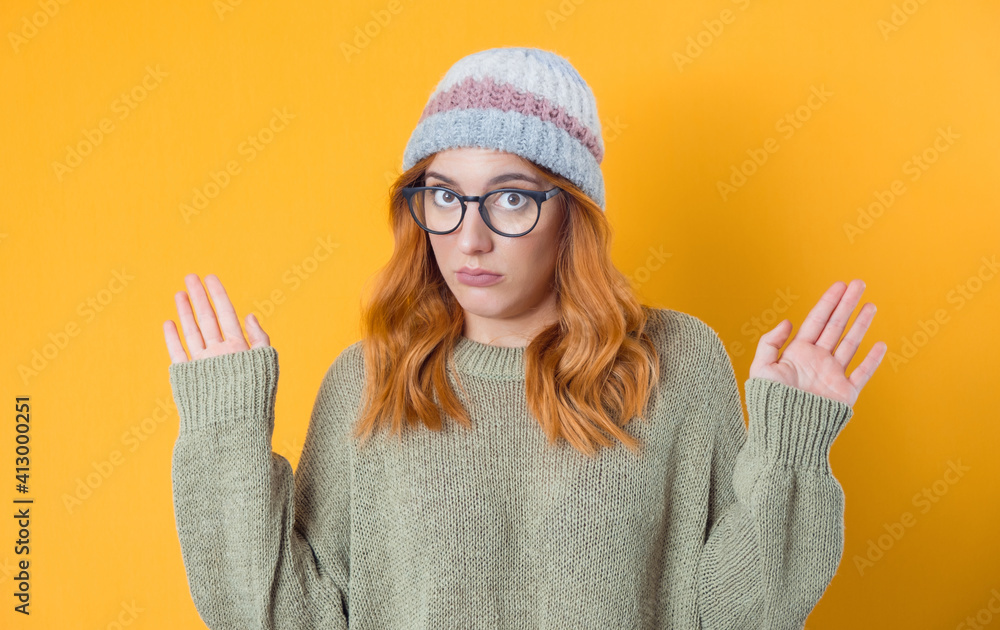 Clueless young woman against white background being in confusion with stretched arms opened palms, isolated on white background Clueless young woman against white background being in confusion with stretched arms opened palms, isolated on white background