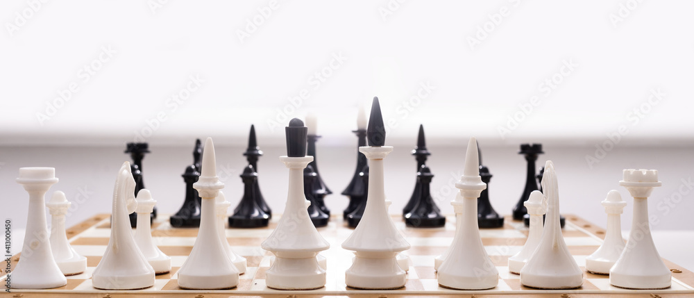 Board game chess with chess pieces in front of white background