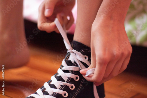 close up of a person tying his shoes