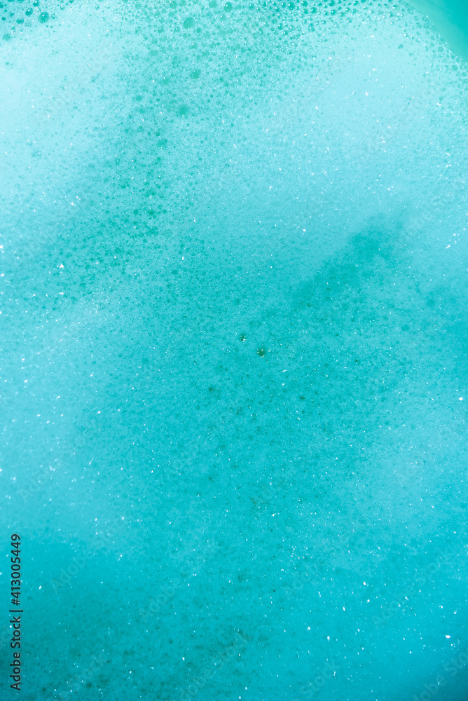 water foam and bubbles of blue color as background. cosmetology concept water foam and bubbles of blue color as background. cosmetology concept
