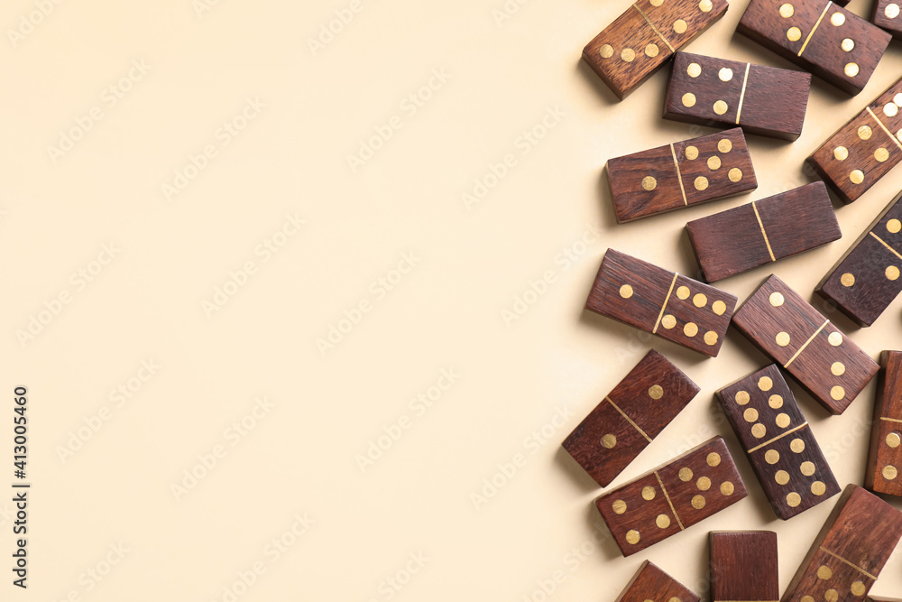 Wooden domino tiles on beige background, flat lay. Space for text Wooden domino tiles on beige background, flat lay. Space for text