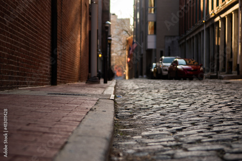 Cobblestone Street in a City at Sunset © DeLucia Digital