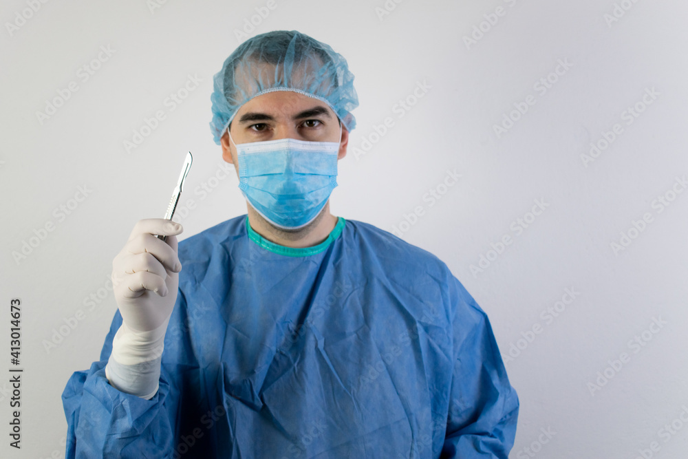 young male surgeon stand doctor health care help people hand hold scalpel young male surgeon stand doctor health care help people hand hold scalpel