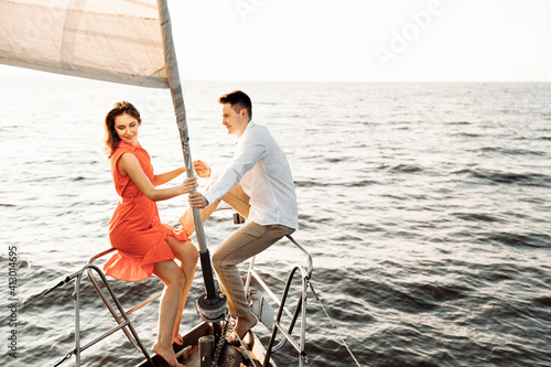 Couple in love on a yacht in the blue sea.