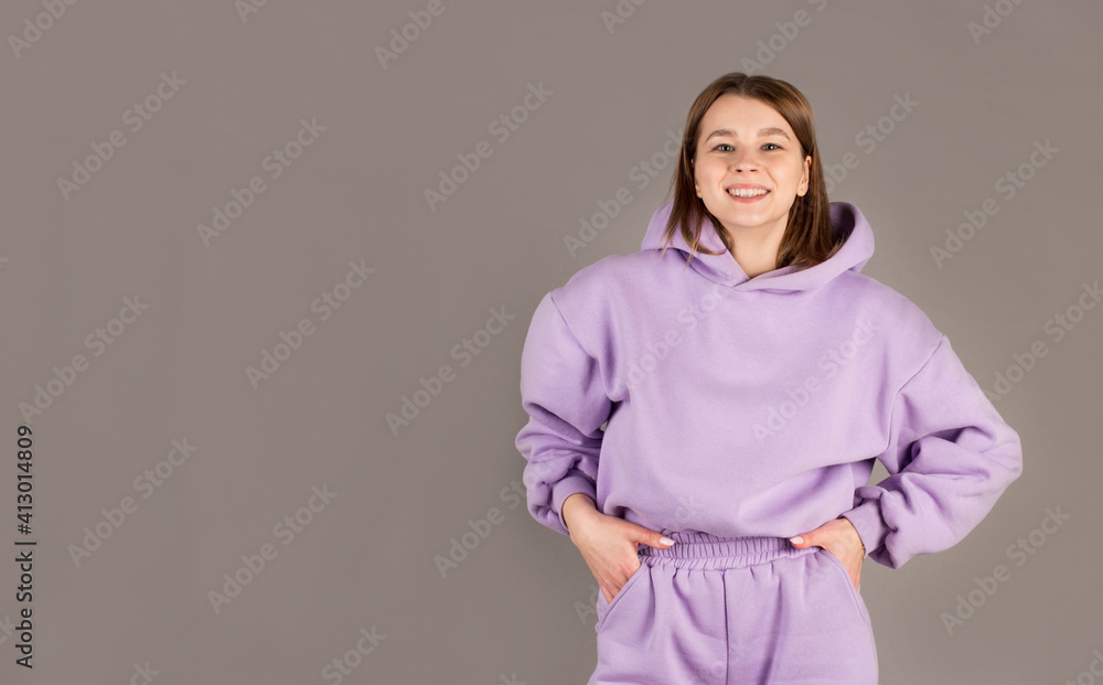 Obraz premium Happy cheerful young woman rejoicing at positive news or birthday gift, looking at camera with joyful and charming smile. Student girl relaxing indoors after college
