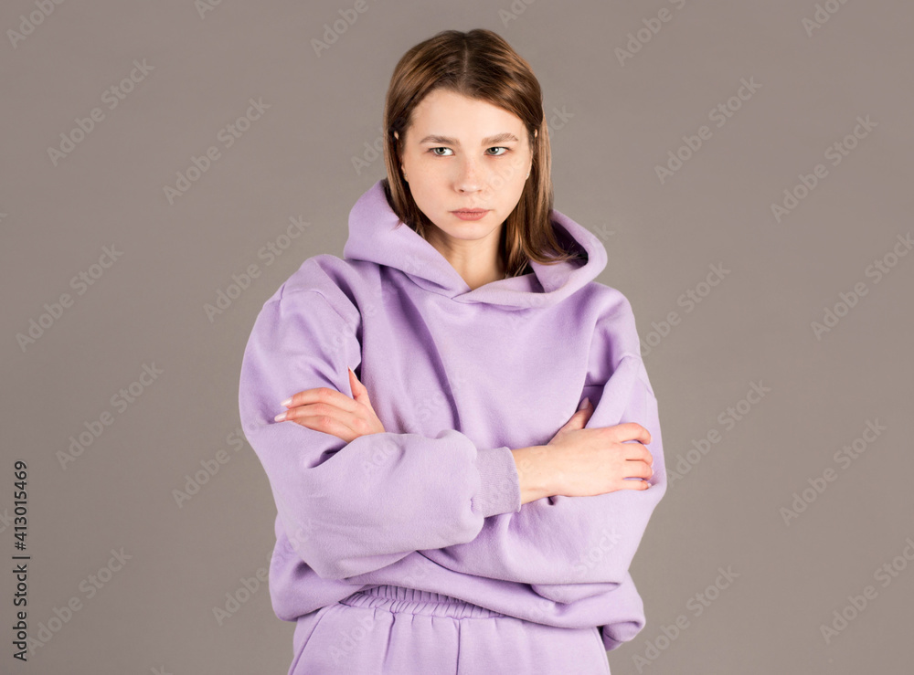 Indoor shot of angry grumpy young female dressed casually keeping arms folded, looking at camera with strict and skeptical expression, doesn't believe excuses of her unfaithful boyfriend Indoor shot of angry grumpy young female dressed casually keeping arms folded, looking at camera with strict and skeptical expression, doesn't believe excuses of her unfaithful boyfriend