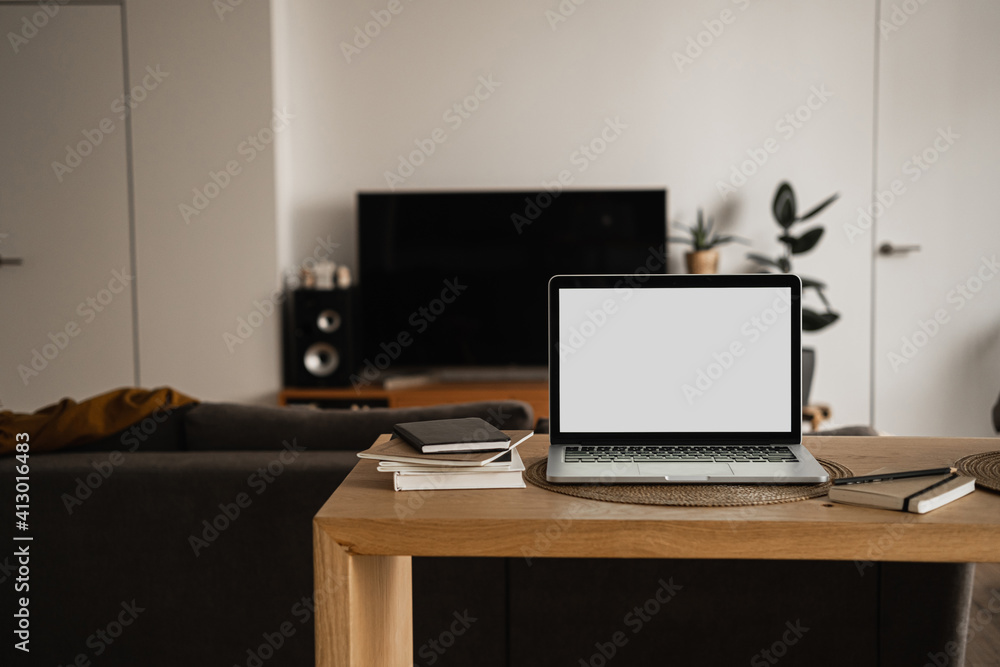Blank screen laptop computer. Home office desk table workspace. Modern nordic interior design. Copy space mockup template. Front view work at home, pandemic quarantine self-isolation business concept. Blank screen laptop computer. Home office desk table workspace. Modern nordic interior design. Copy space mockup template. Front view work at home, pandemic quarantine self-isolation business concept.