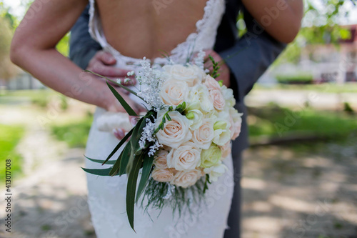 Shallow focus of a couple getting married in a park under the sunlight