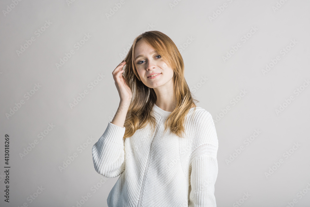Portrait of a stylish and smiling girl on a white background in the studio Portrait of a stylish and smiling girl on a white background in the studio
