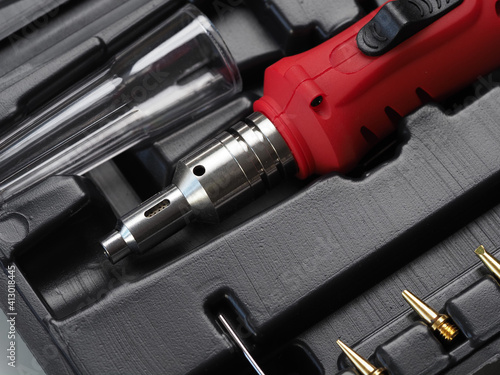 red gas soldering iron in black plastic box