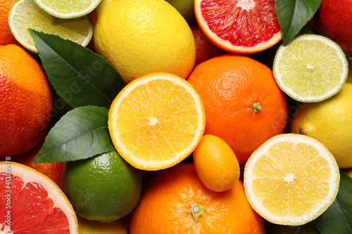 Different ripe citrus fruits as background  closeup