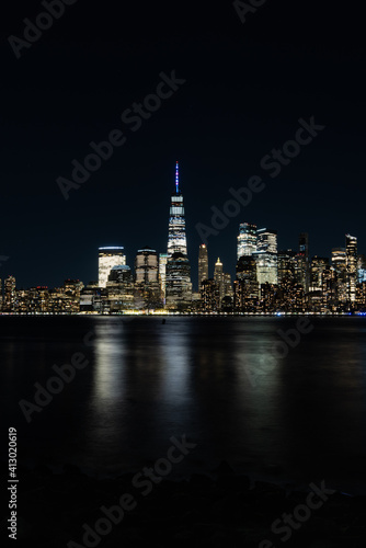 New York City Skyline at Night with reflection of the skyline in the Hudson river © DeLucia Digital