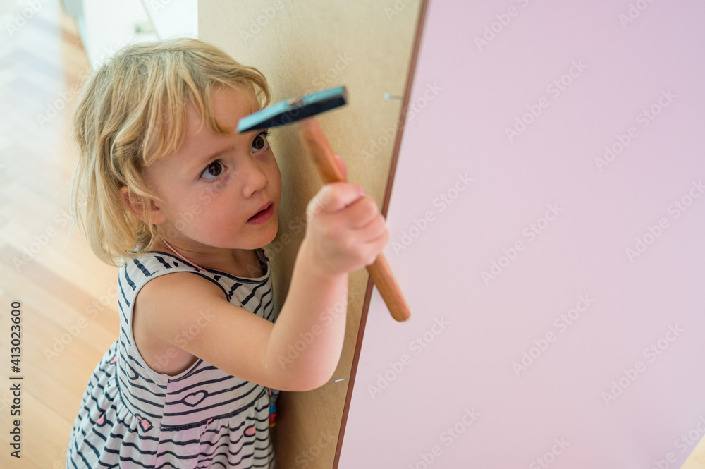 Cute blonde girl renovating her room building a closet. Cute blonde girl renovating her room building a closet.