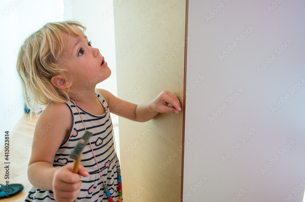 Cute blonde girl renovating her room building a closet. Cute blonde girl renovating her room building a closet.