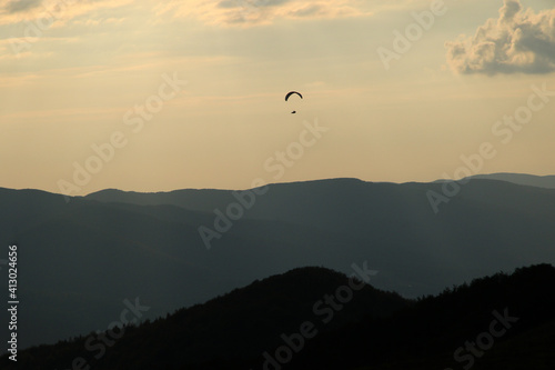 Paraglider silhouette at sunset in Bieszczady Mountains, Poland