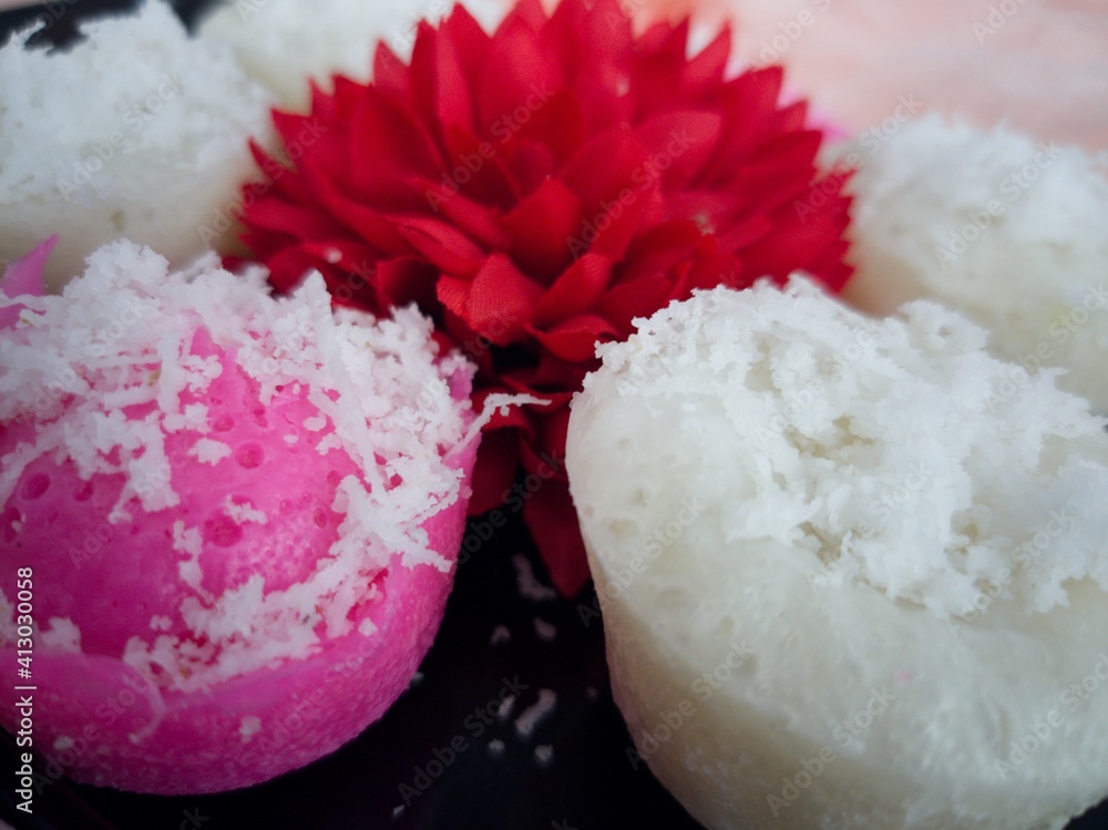 Fluffy and delicious steamed rice cake or locally known as apam beras or apam nasi with grated coconut on top. Selective focus points. Blurred background Fluffy and delicious steamed rice cake or locally known as apam beras or apam nasi with grated coconut on top. Selective focus points. Blurred background