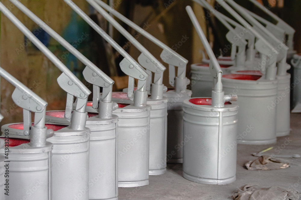 Gray-red hand pumps for pumping any liquid close-up Gray-red hand pumps for pumping any liquid close-up