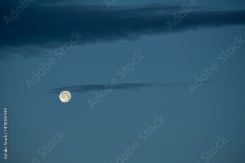 Sky with full moon with small clouds