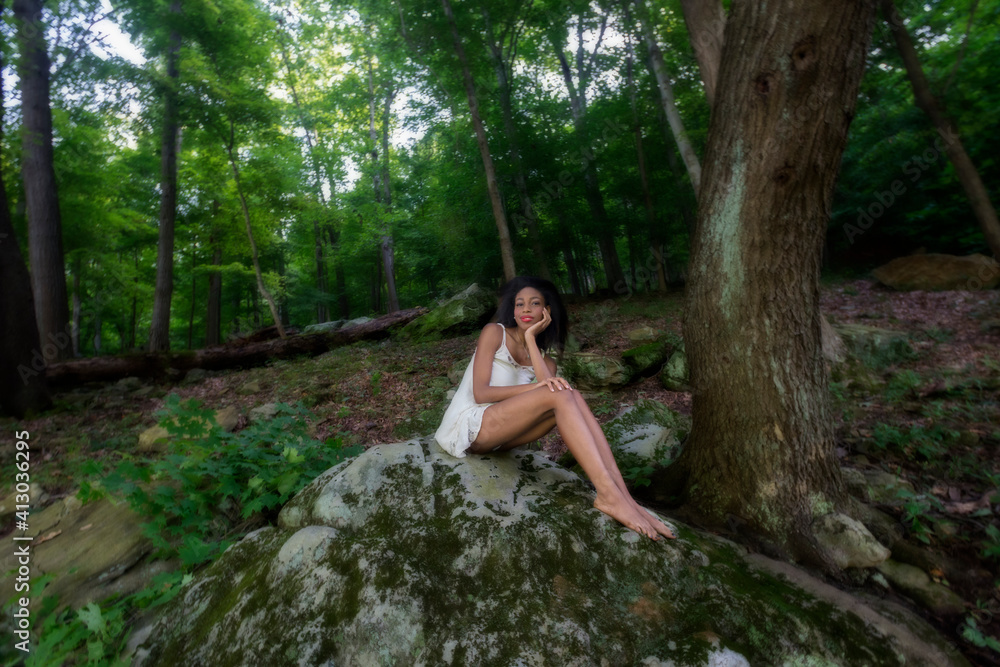 Woman at lake on swing, large boulder, and in water Woman at lake on swing, large boulder, and in water