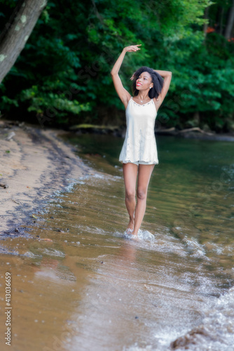 Woman  at lake on swing  large boulder  and in water